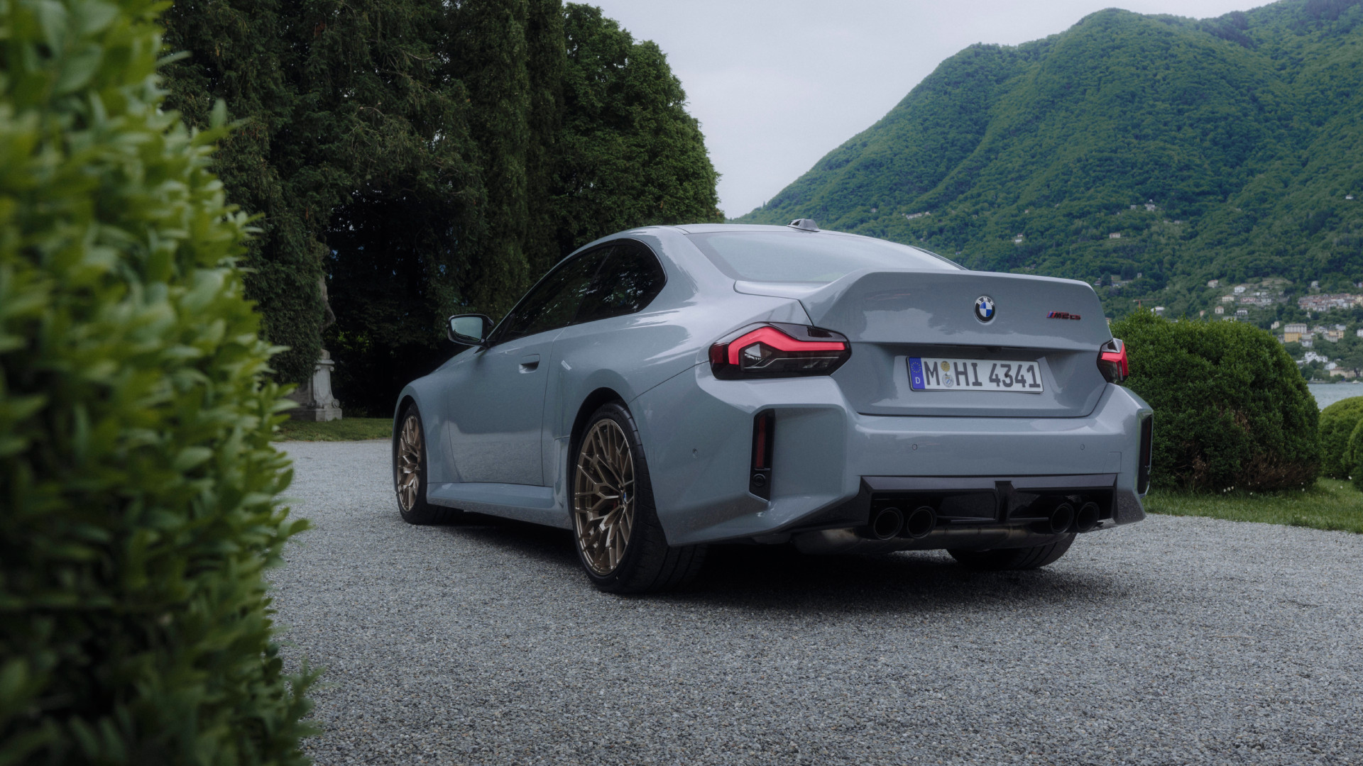 p90600961-highres-1 2026 BMW M2 CS in front of a lakeside estate, rear view.