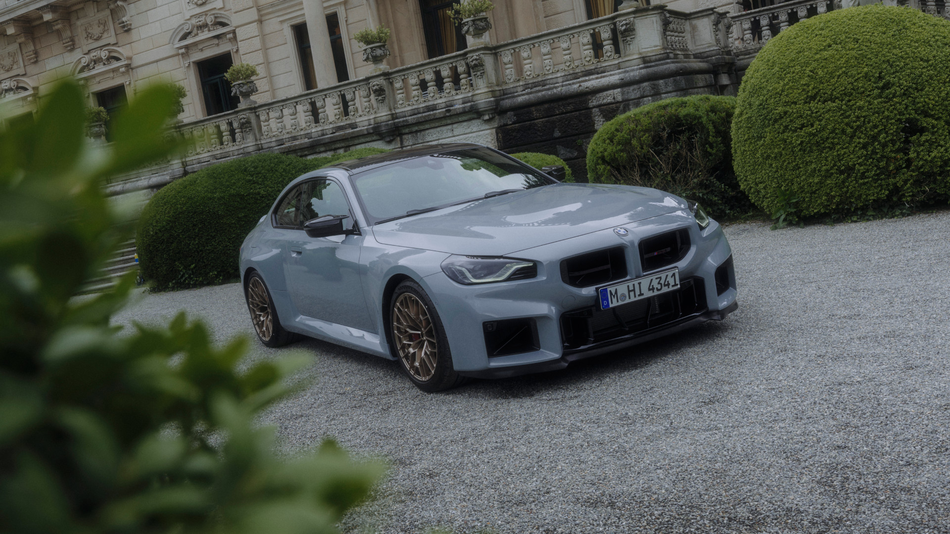 2026 BMW M2 CS in front of a lakeside estate.