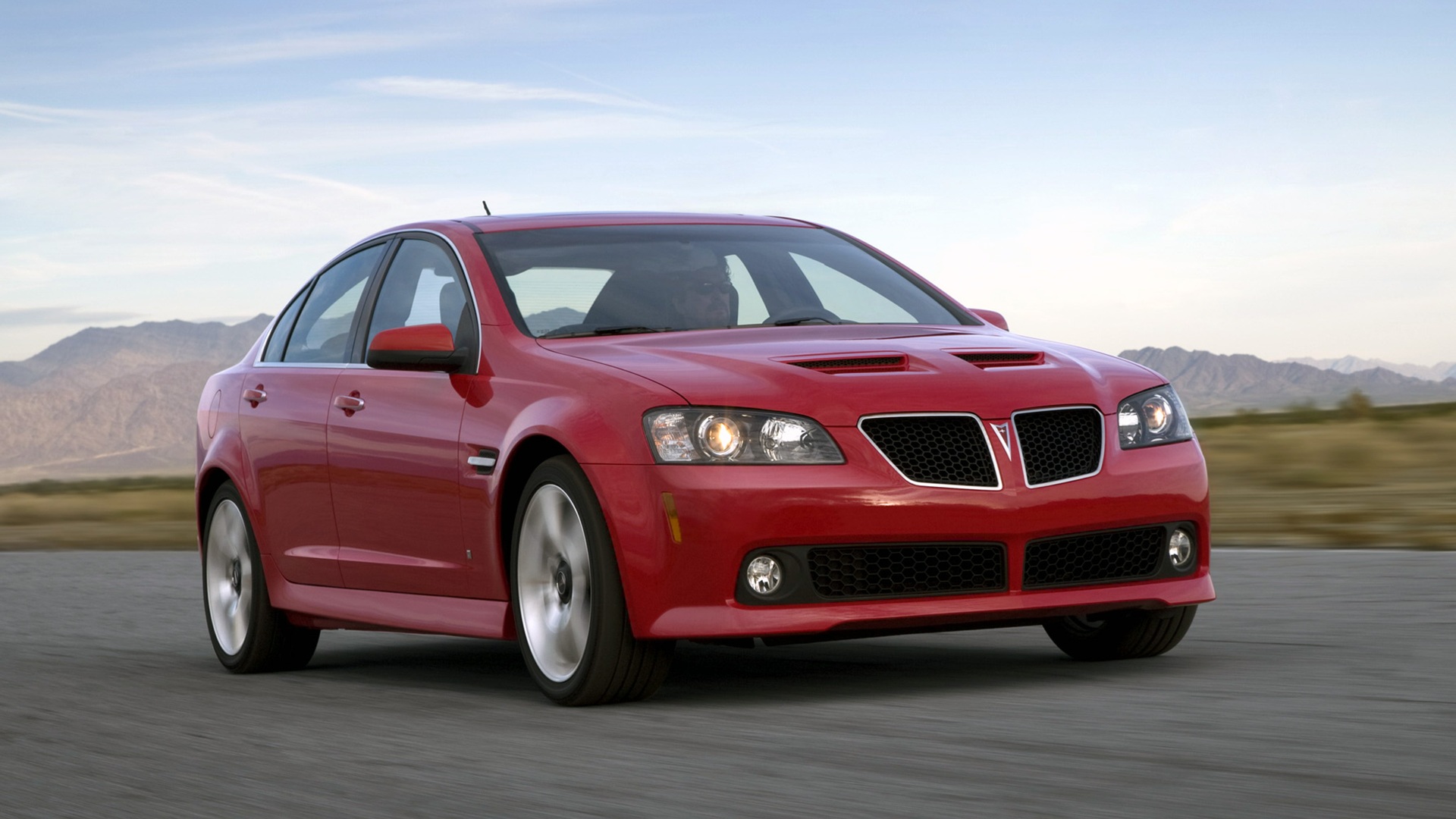 pontiac_g8_gt-1 A Pontiac G8 driving on pavement with a scenic background.