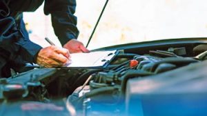 Mechanic inspecting a car's engine bay