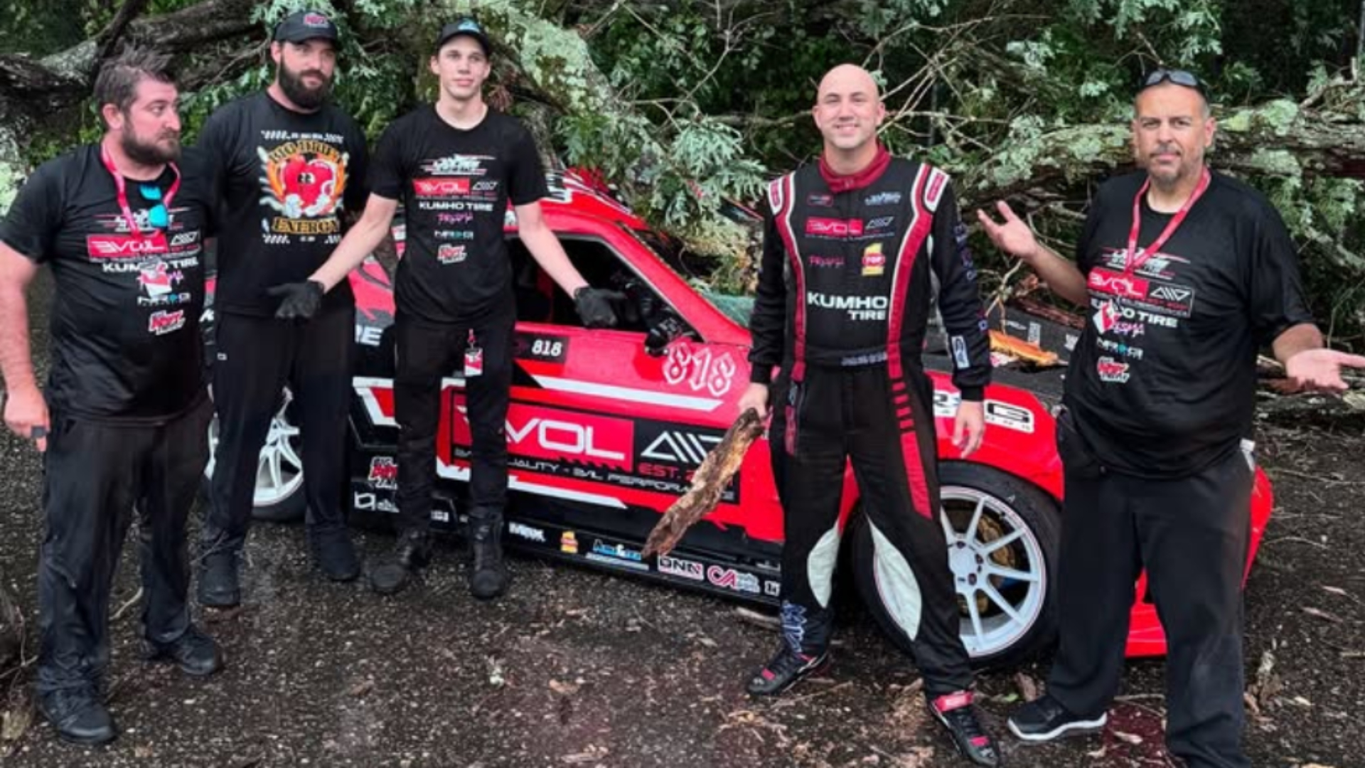 crew-1 Formula D racer Jeff Jones and crew in front of their weather-damaged drift car.