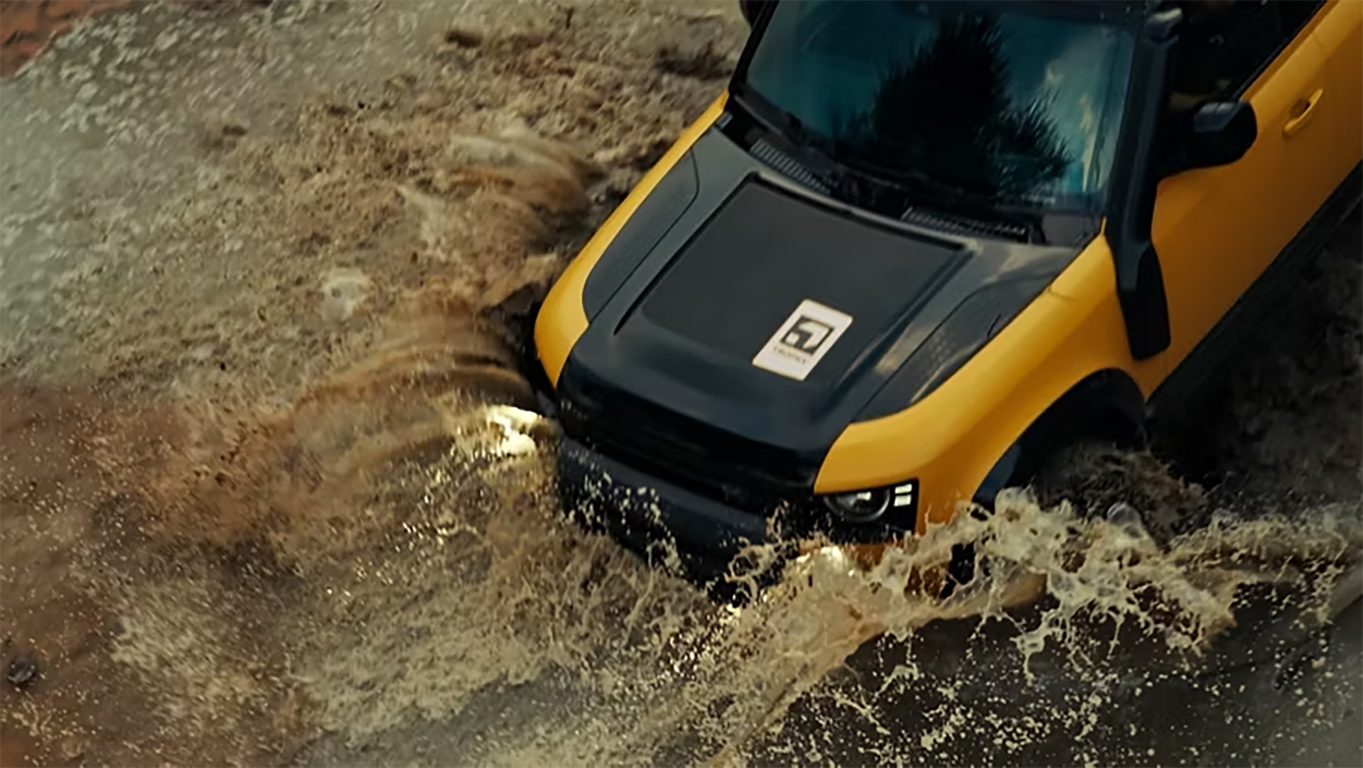 defender-trophy2 Land Rover Defender bashing through a puddle.