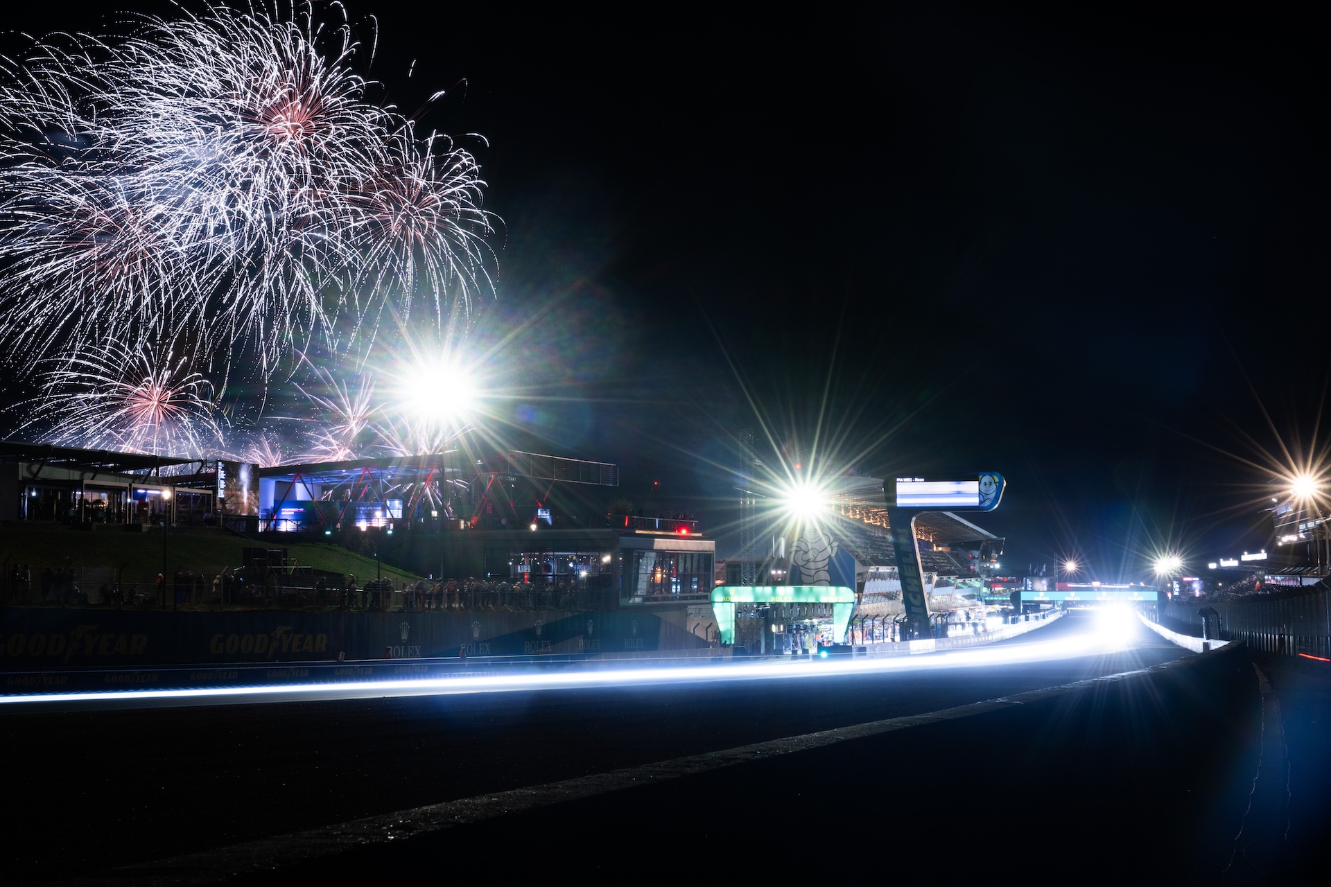 gettyimages-2219552179 LE MANS, FRANCE - JUNE 15: A fireworks display and car headlight light streaks at night during the Le Mans 24 Hour Race on June 15, 2025 in Le Mans, France. (Photo by James Moy Photography/Getty Images)