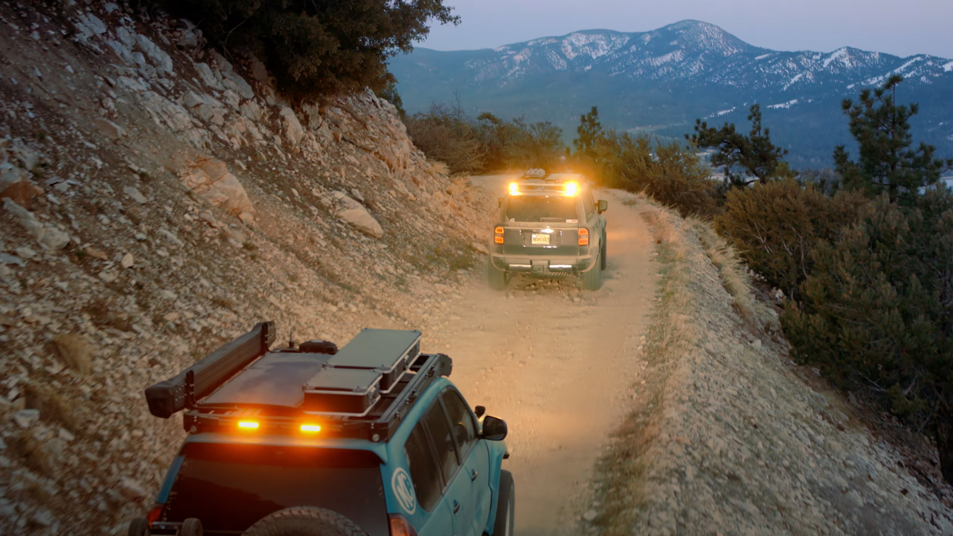 kc4 Overland trucks with yellow dust lights.