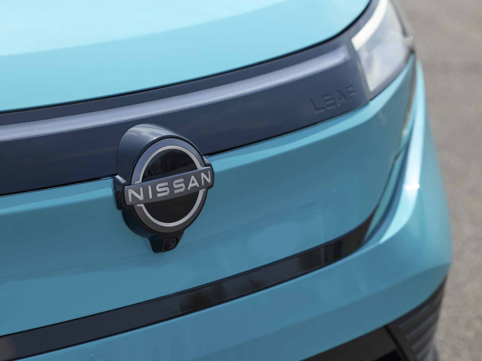 leaf-e-250308_all-new_nissan_leaf_dynamic_pictures_26 2026 Nissan Leaf front emblem detail.