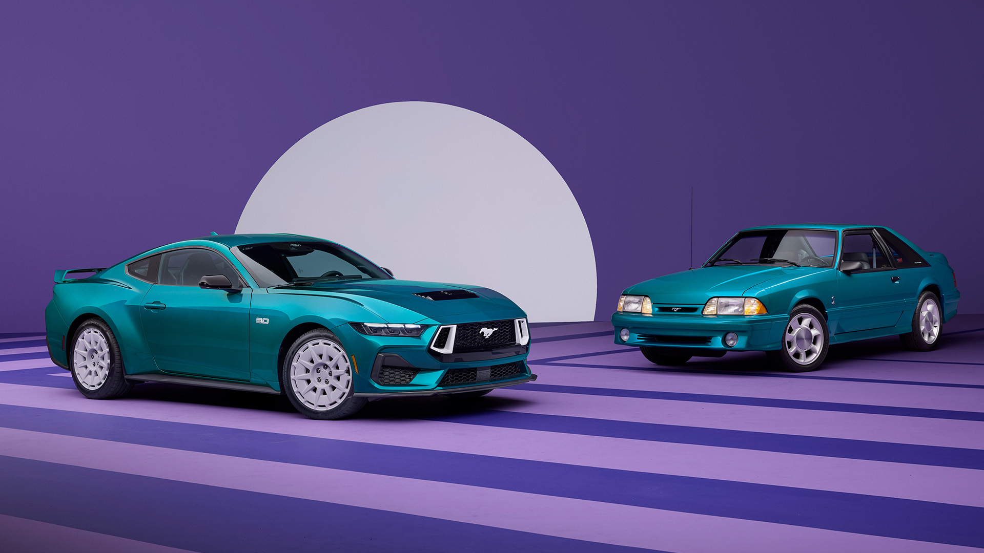 new-fox-body-hero-1-1 A new Ford Mustang GT parked beside a classic Fox Body Mustang.