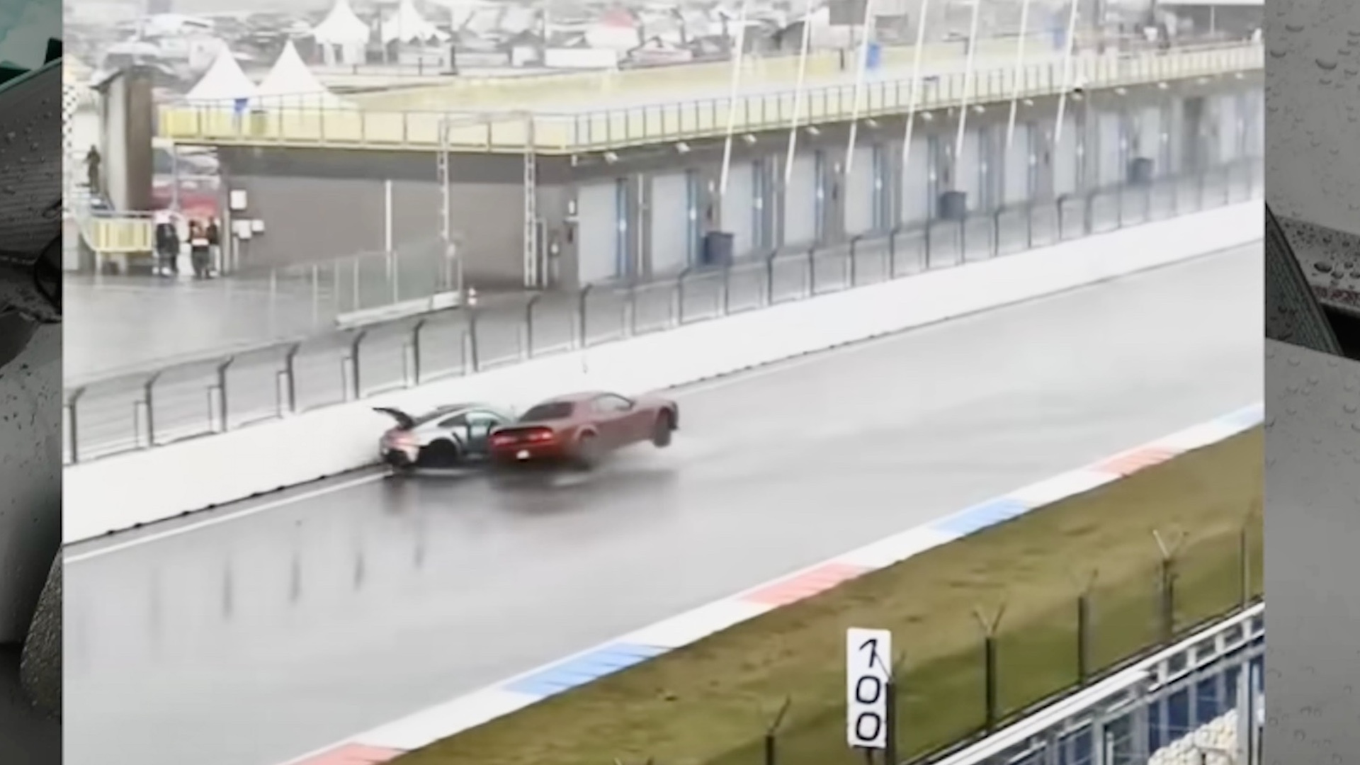 A Porsche 911 GT3 RS and Dodge Challenger crash on a race track.