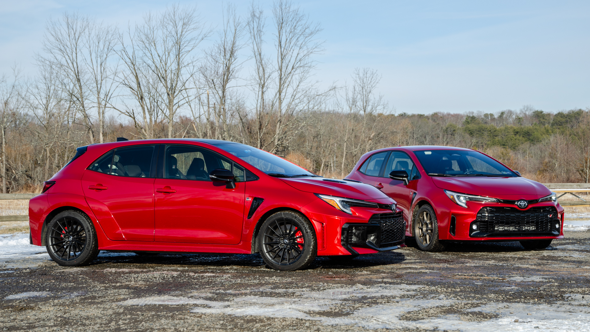 toyota-gr-corolla-transmissions-comparison-4-1 2025 Toyota GR Corolla next to 2024 GR Corolla in park, both red.